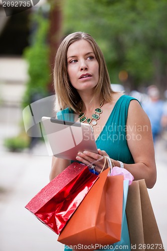 Image of Shopping Woman holding Digital Tablet