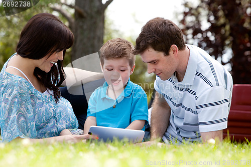 Image of Family in Park with Digital Tablet
