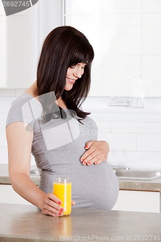Image of Pregnant Woman Looking Down at Belly