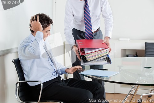 Image of Businessmen Overwhelmed By Load Of Work