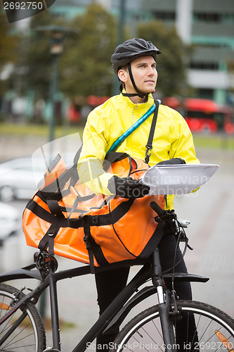 Image of Male Cyclist With Package