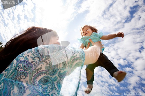 Image of Mother Throwing Daughter into Sky