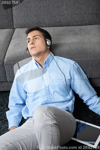 Image of Man Listening Music On Digital Tablet