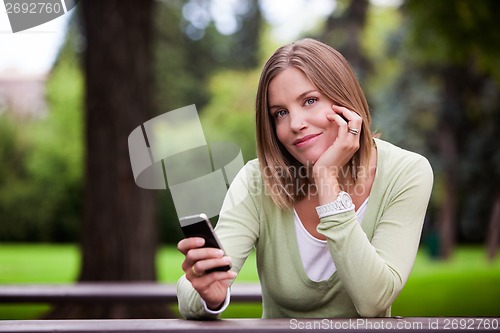 Image of Woman holding Cell Phone