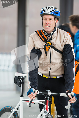 Image of Young Male Cyclist With Backpack