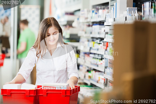 Image of Pharmacist Stocking Shelves in Pharmacy