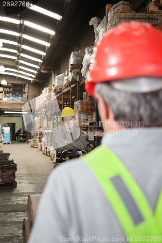 Image of Foreman With Arms Crossed Standing At Warehouse