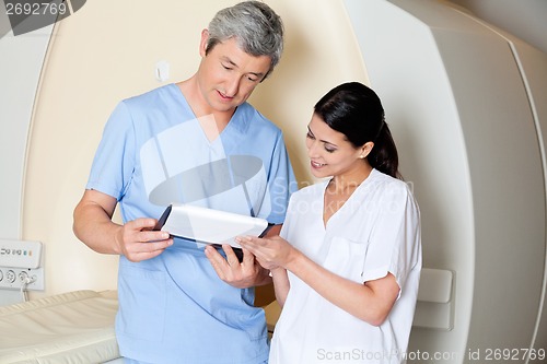 Image of Technicians Looking At Clipboard