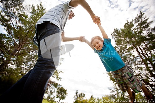 Image of Father and Son Playing in Park