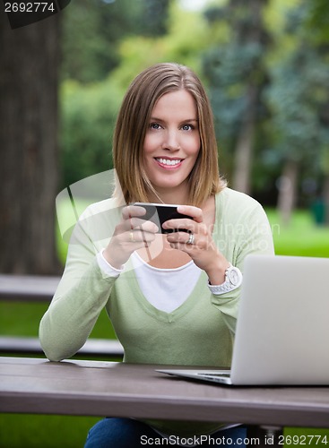 Image of Woman holding Cell Phone