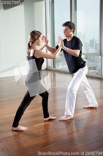 Image of Young Partners Practicing Yoga Exercise