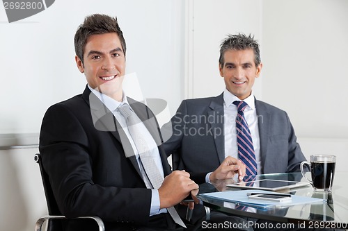 Image of Businessmen Using Digital Tablet In Office