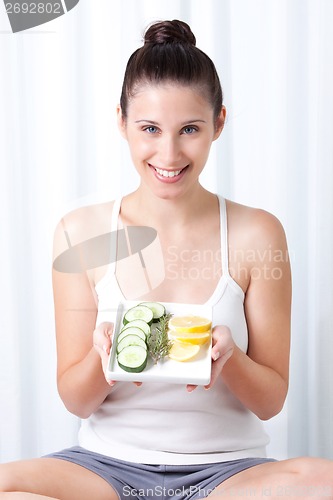 Image of Young Woman holding salad