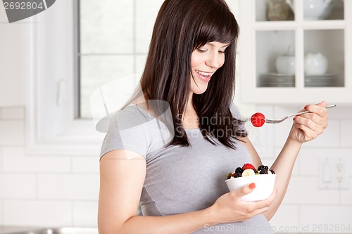 Image of Pregnant Woman Eating Fresh Fruit