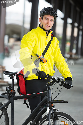 Image of Young Male Cyclist With Bag