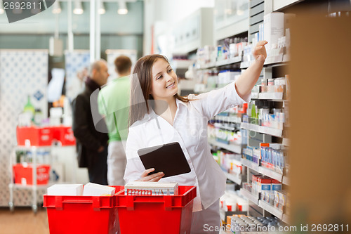 Image of Smiling Woman Using Digital Tablet For Shopping At Supermarket