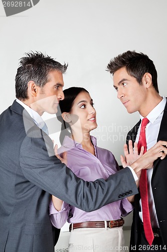 Image of Businesswoman Acting As Peacemaker Between Colleagues