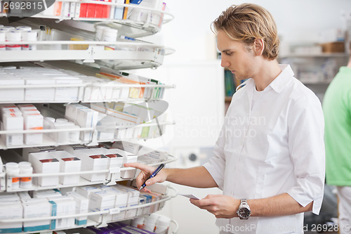 Image of Male Pharmacist Filling Prescription