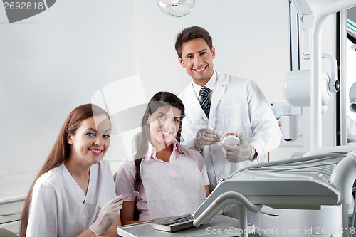 Image of Dentist And Nurse With Patient In Clinic