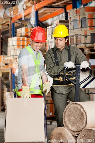 Image of Foreman Showing Something To Coworker At Warehouse