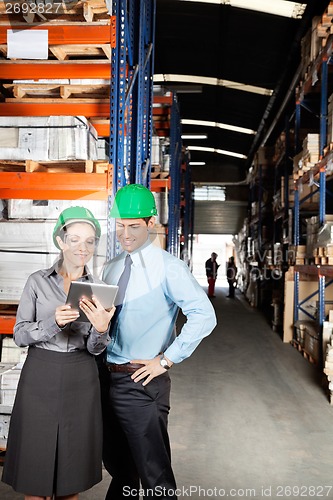 Image of Supervisors Using Digital Tablet At Warehouse