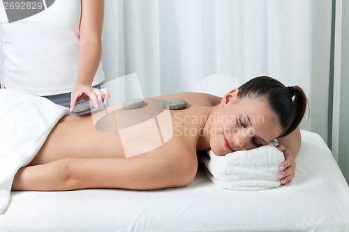 Image of Woman Receiving a Stone Massage