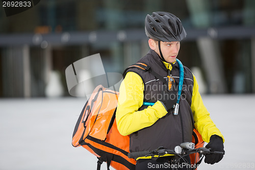 Image of Young Courier Delivery Man Using Walkie-Talkie