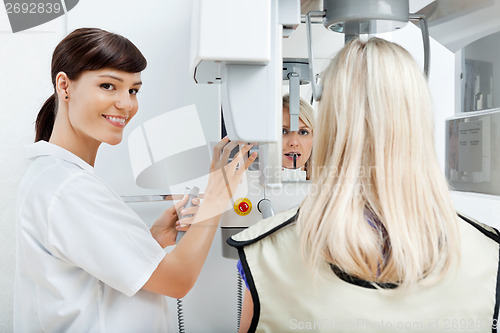Image of Female Dentist Getting Her Patient's Teeth X-Rayed