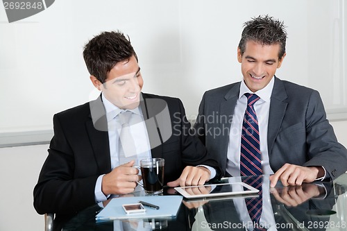 Image of Businessmen Using Digital Tablet In Office