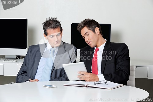 Image of Businessmen Using Digital Tablet At Desk