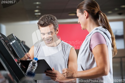 Image of Instructor With Client In Health Club