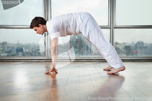 Image of Man Practicing Yoga At Gym