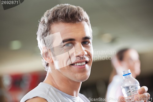 Image of Man Holding Water Bottle In Health Club
