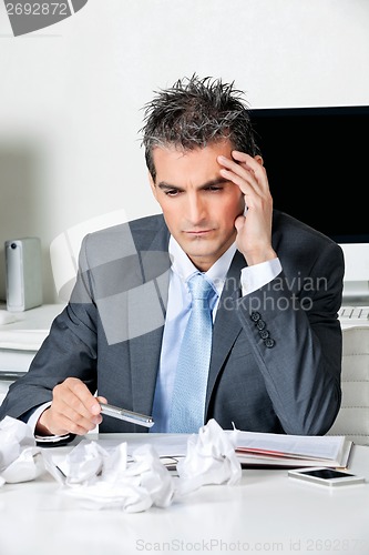 Image of Tensed Businessman Sitting At Desk