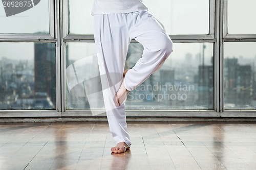 Image of Man Practicing Yoga In Tree Pose