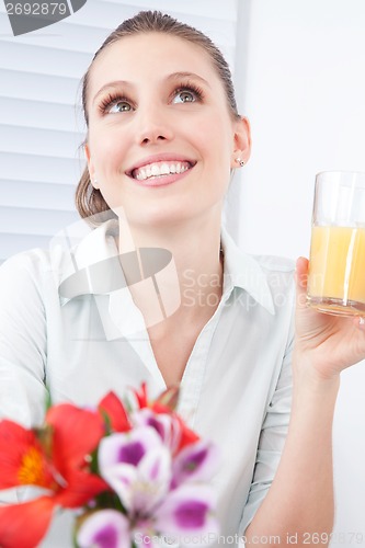 Image of Young Woman Holding Juice Glass