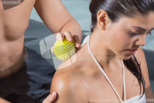 Image of Woman Receiving Back Massage In Pool