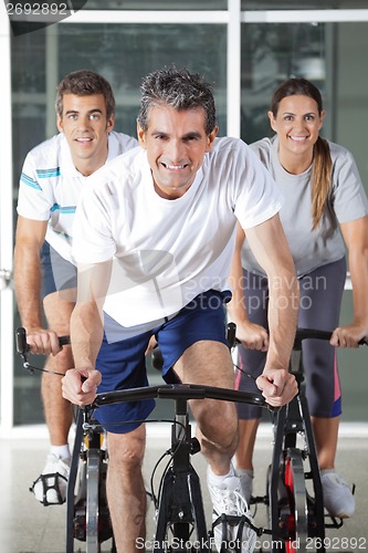 Image of Men And Woman On Spinning Bikes