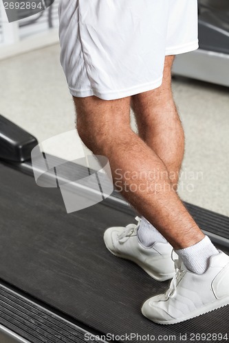 Image of Man Walking On Treadmill In Health Club