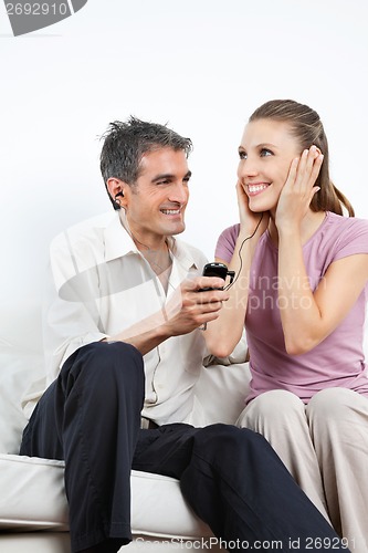 Image of Couple Listening Music On Cell Phone