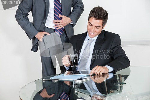 Image of Businessman Using Digital Tablet In A Meeting With Colleague