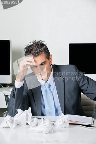 Image of Tensed Businessman Sitting At Desk