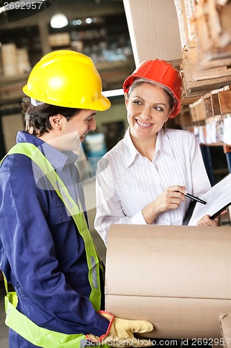 Image of Supervisor Showing Clipboard To Foreman