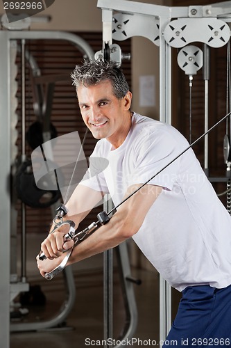 Image of Mature Man Working Out In Fitness Center