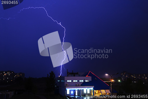 Image of Severe lightning storm over a city buildings