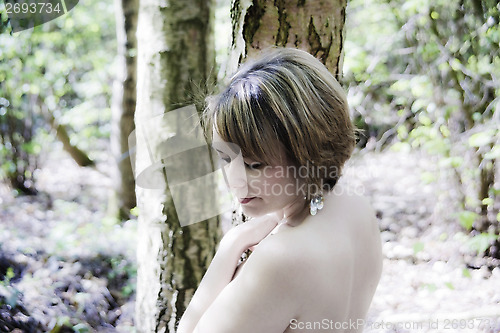 Image of high key portrait of woman in woodland