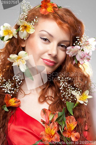 Image of Portrait of beautiful woman with spring flowers