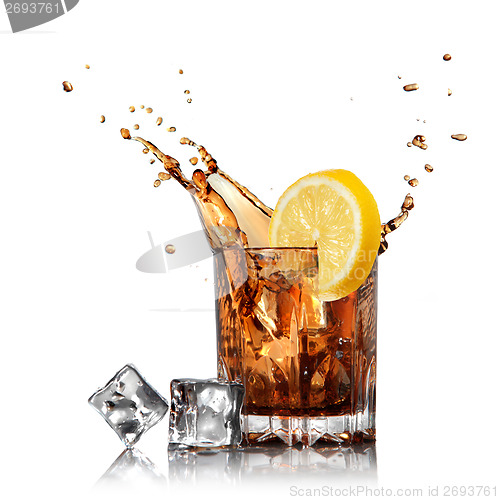 Image of splash of cola in glass with lemon and ice isolated on white