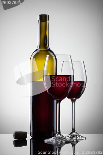 Image of Wine in glasses and bottle on white