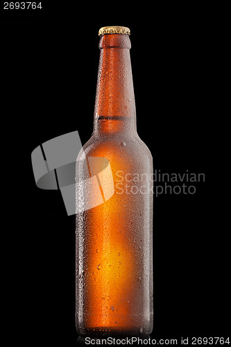 Image of Beer bottle with water drops and frost isolated on black